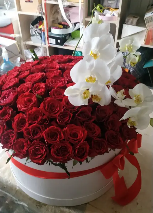 Orchids and roses  in a hat box
