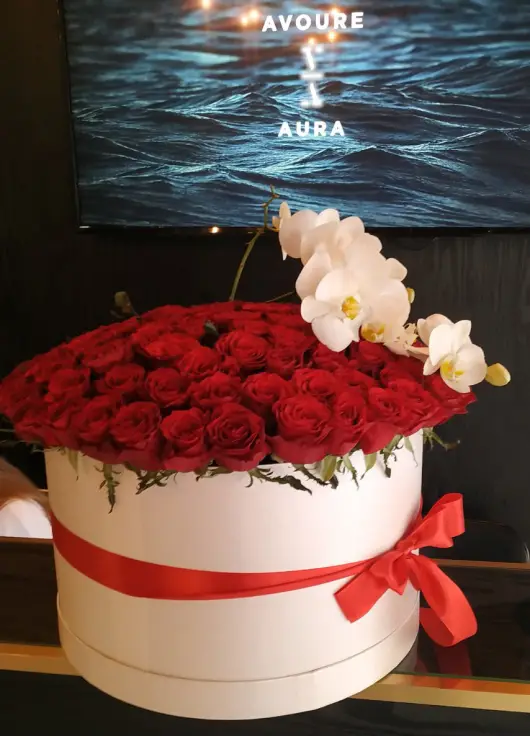 Orchids and roses  in a hat box
