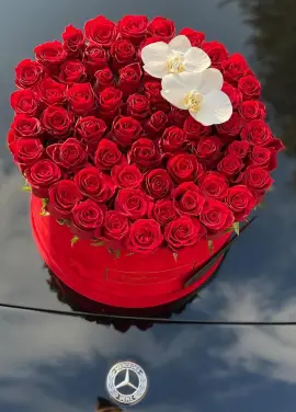 Orchids and roses  in a hat box