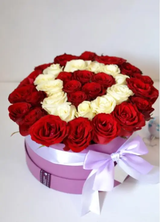 35 red and white roses in a box