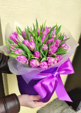 Violet tulips in a hat box