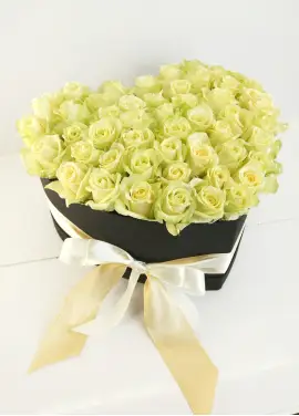 White roses in a heart box